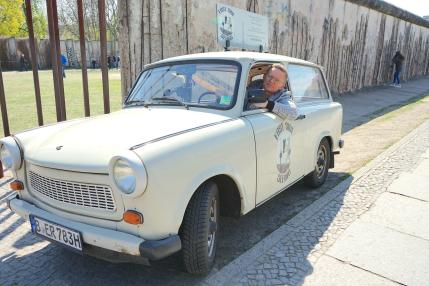 Eastsideseeing Trabant car in front of the Berlin Wall