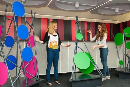 Girls standing next to an installation