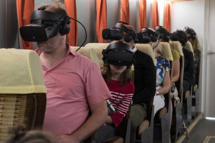 sitting people with Virtual Reality glasses