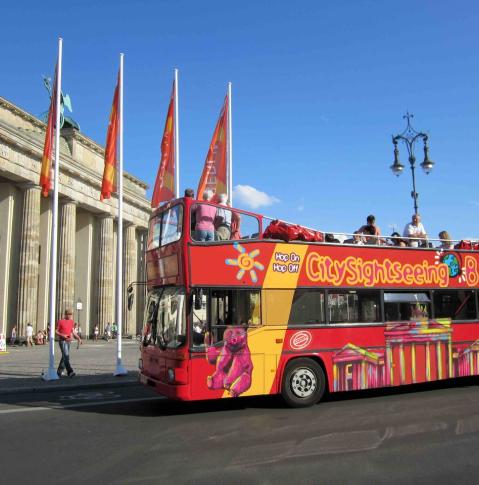 Berlin City Tour Bus in fronf of the Brandenburg Gate