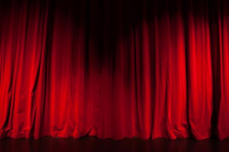 Curtain from the theatre with a spotlight as background